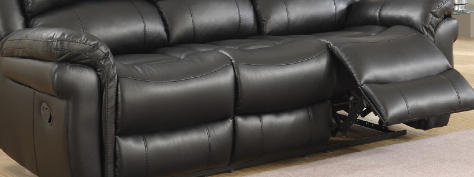 Close-up of 3-seater power recliner sofa in black leather finish