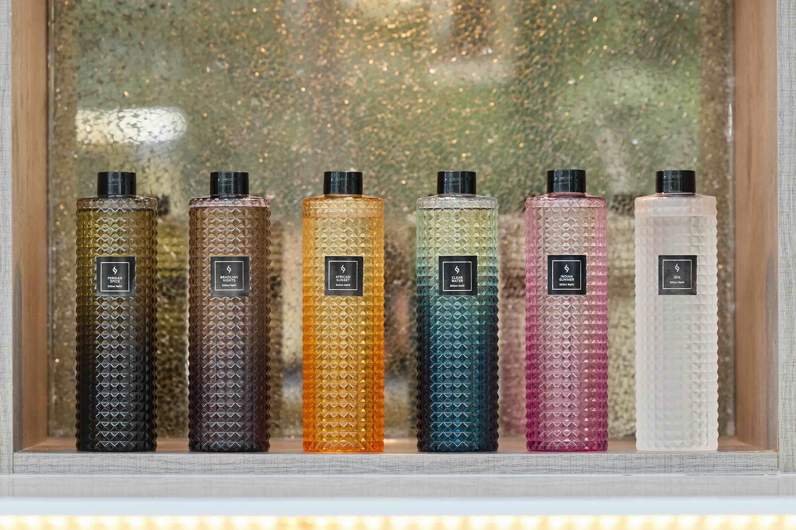 The full collection of Sensum's six Reed Diffuser refill scents in 500ml sizes. Fragrances include Signature Scent, Spa, Brazilian Nights, Indian Summer, African Sunset, and Clear Water.