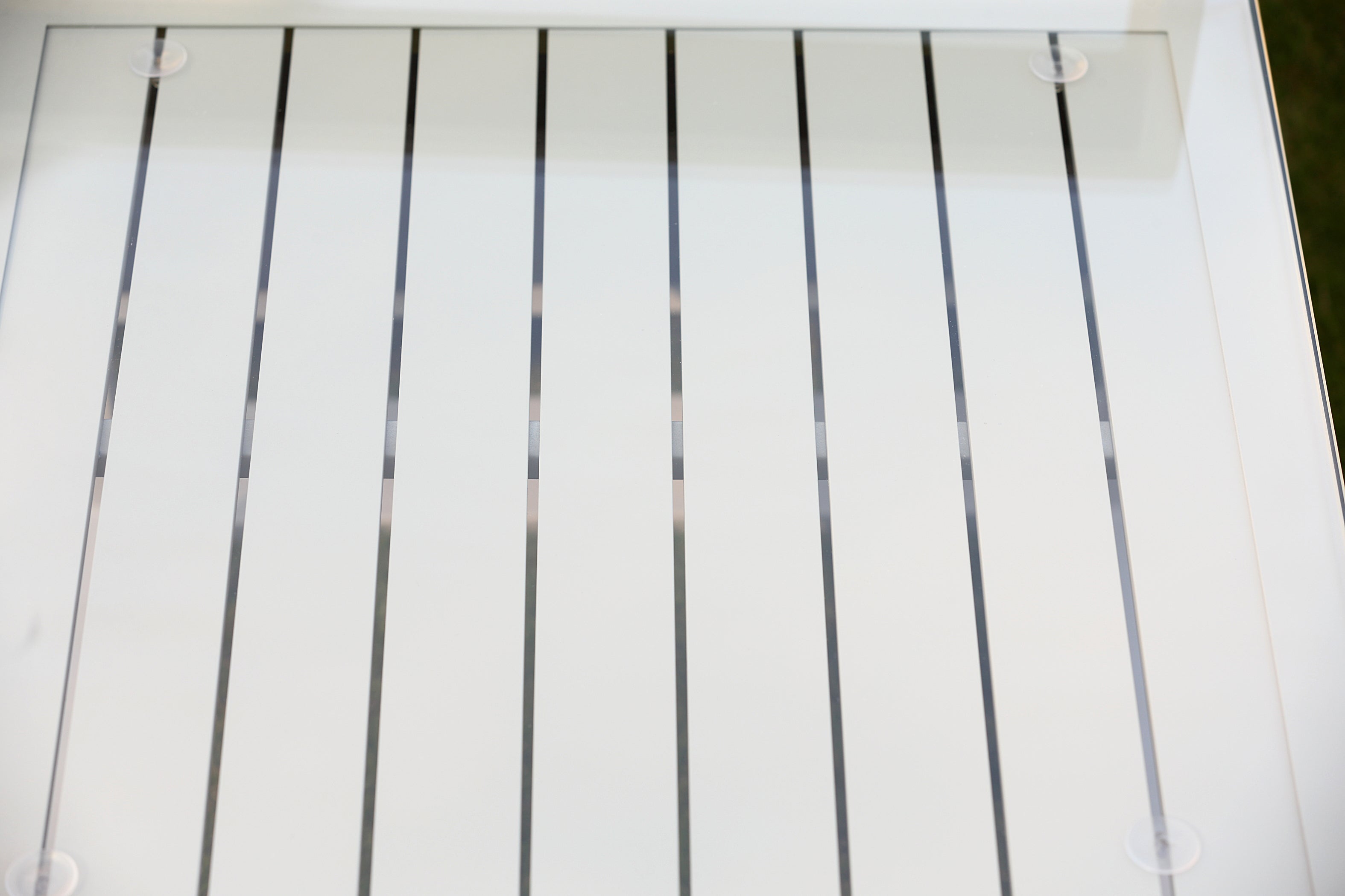 Close-up outdoor garden side table, white, glass top