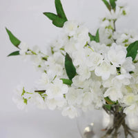 White Artificial Plum Blossom Arrangement in Round Vase